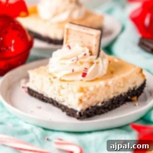 Peppermint Cheesecake Bars topped with whipped cream and candy canes.