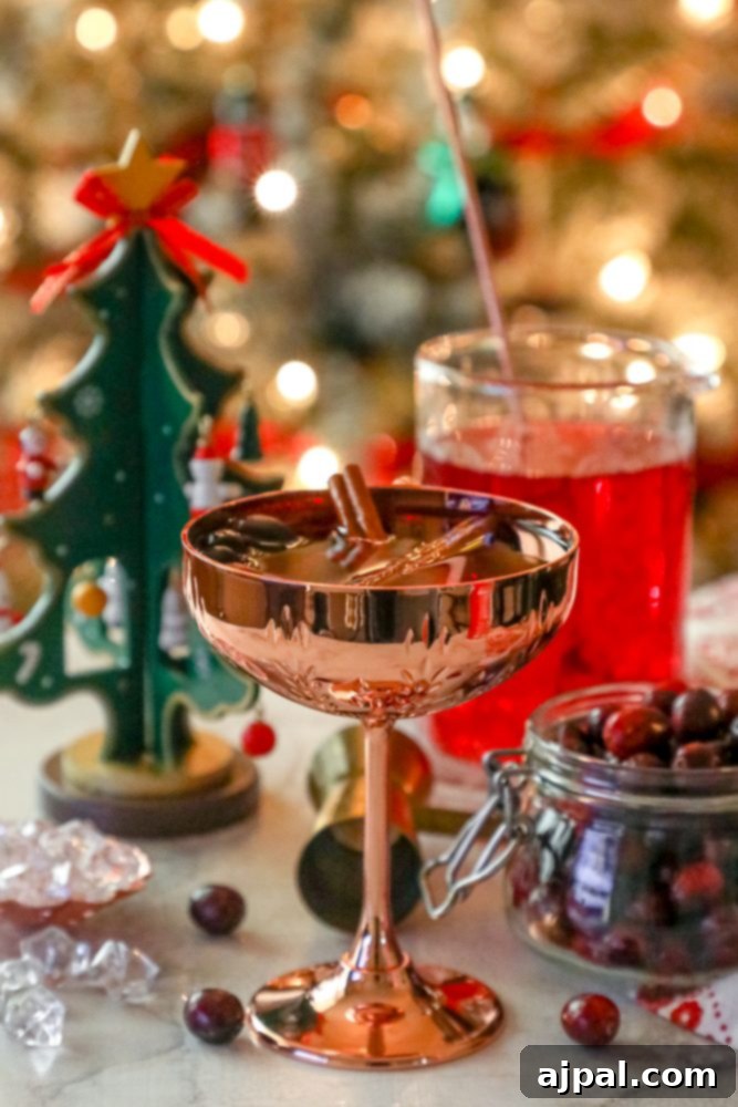 An easy Christmas cocktail featuring cranberries and a festive touch of a Christmas tree.