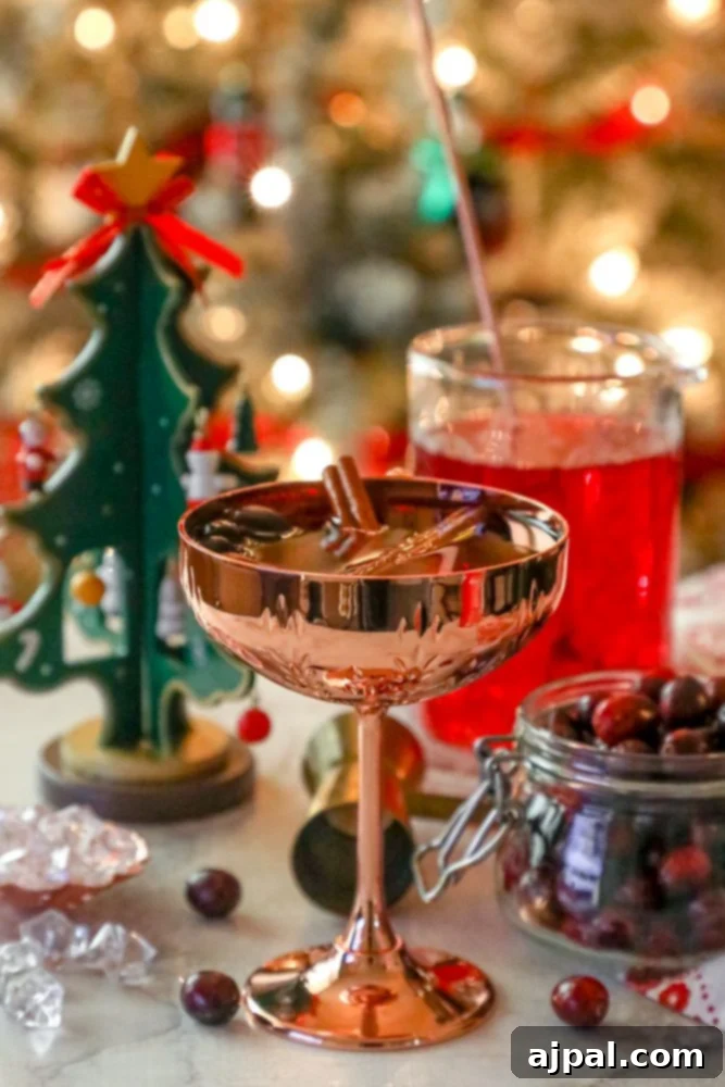 An easy Christmas cocktail featuring cranberries and a festive touch of a Christmas tree.