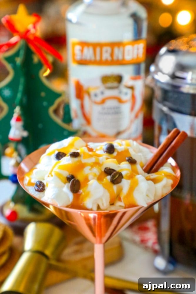 A stunning brass martini glass brimming with a Caramel Espresso Martini, topped with luxurious whipped cream, aromatic espresso beans, and a fragrant cinnamon stick, promising a decadent experience.