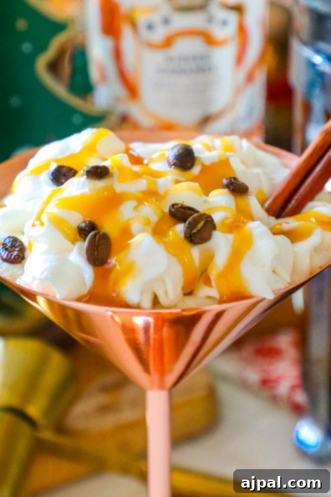 An opulent martini glass, overflowing with a luxurious, creamy whipped coffee concoction, presents an irresistible vision of indulgence.