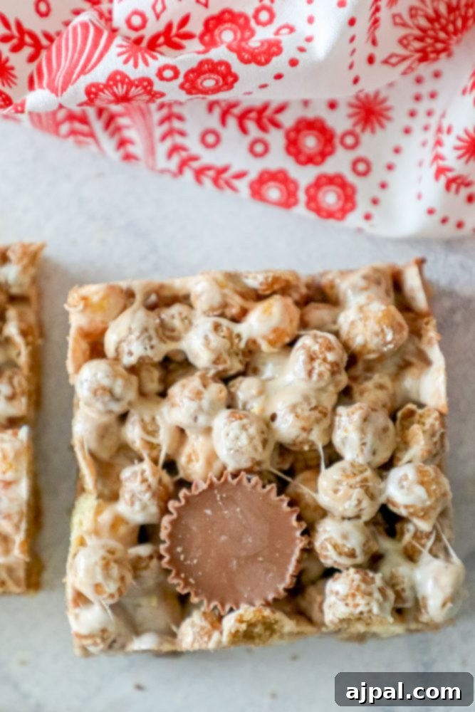 Reese's Peanut Butter Cereal Treats 3 A square of peanut butter and chocolate bars on a white surface, inspired by Reeses Puffs Treats.