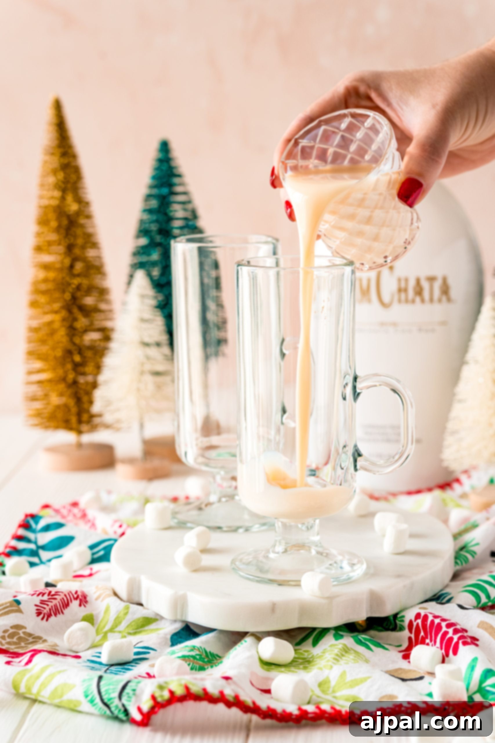 Creamy Rumchata Hot Chocolate Cocktail 10 A person making a Boozy RumChata Hot Cocoa Cocktail Recipe.