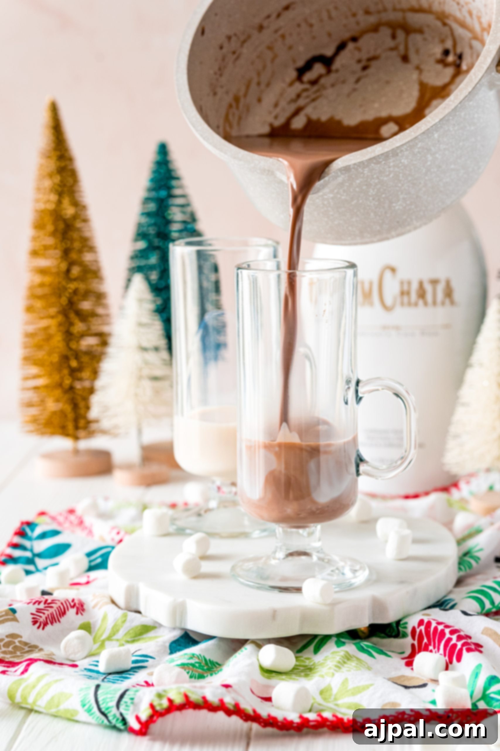 Creamy Rumchata Hot Chocolate Cocktail 11 Boozy hot cocoa is poured into a glass.