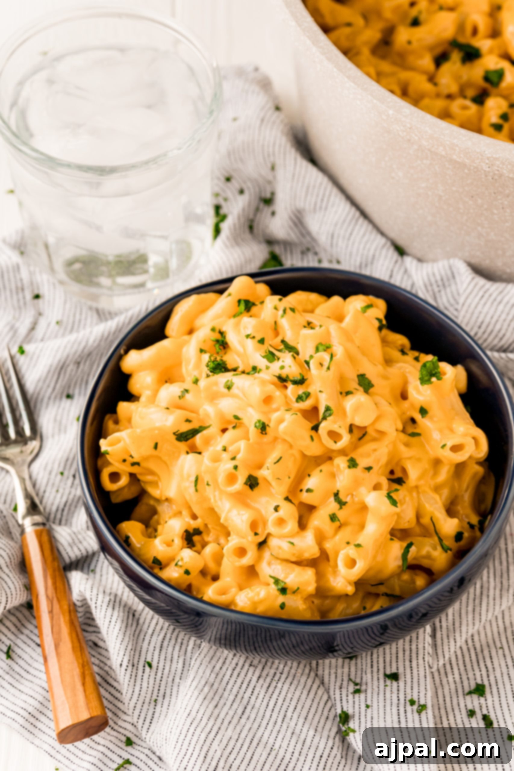 Macaroni and cheese in a bowl with a fork, the Best Easy Mac and Cheese Recipe.