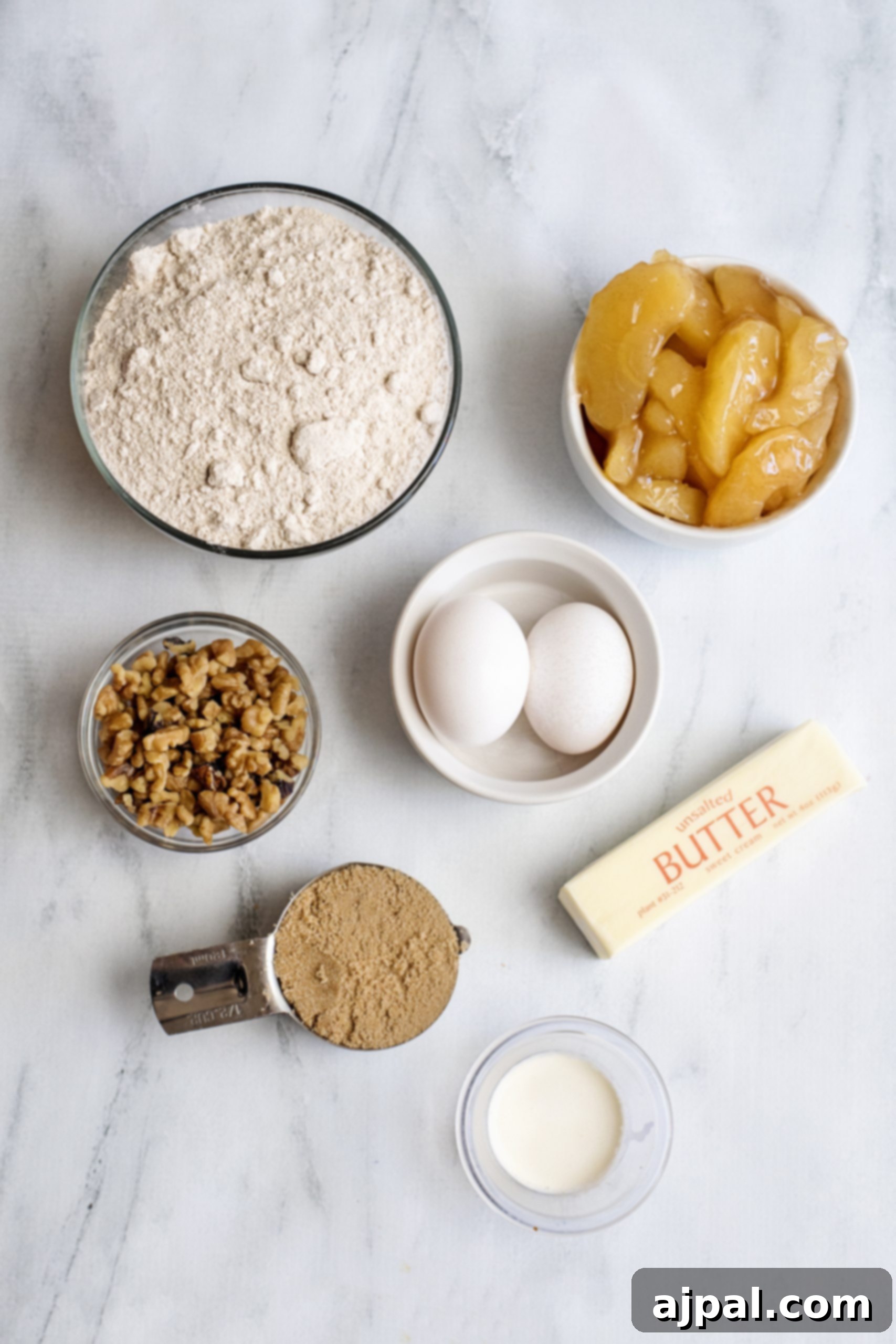 Ingredients laid out for preparing an easy caramel apple spice cake.