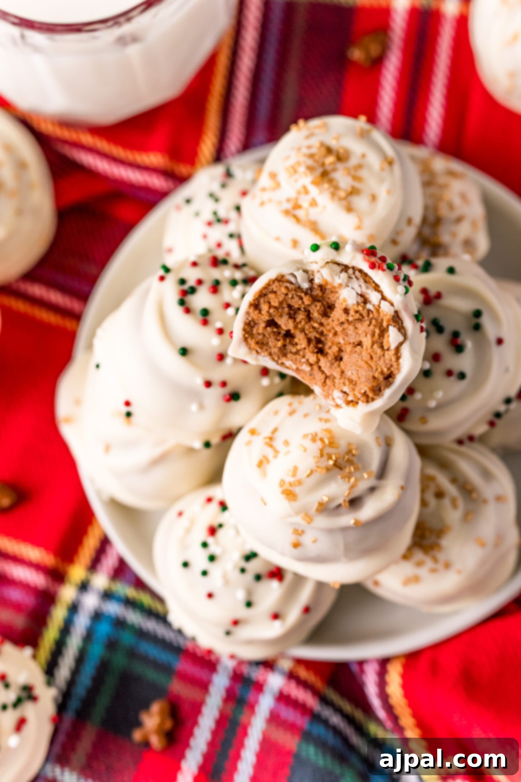 A white plate with perfectly formed gingerbread truffles, ready to be enjoyed.
