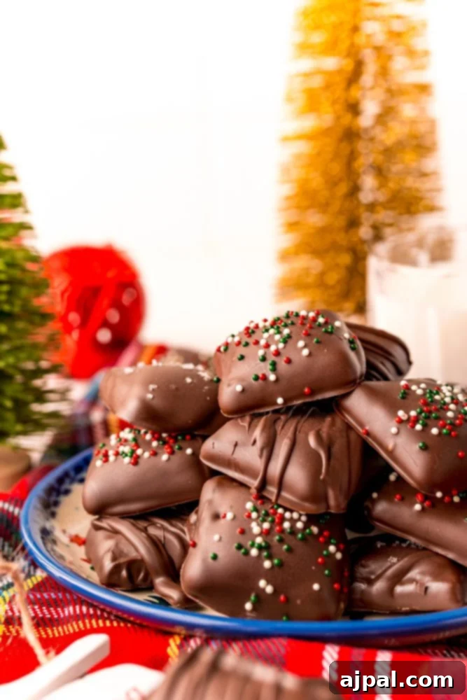 Decadent Millionaire Shortbread Bites Made Easy 2 A plate of golden shortcut millionaire shortbread bars, featuring a thick caramel layer on a buttery shortbread base, all generously coated in rich chocolate, displayed next to a festive Christmas tree. Perfect for easy holiday baking.
