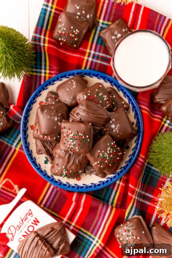 Decadent Millionaire Shortbread Bites Made Easy 7 Decadent chocolate-covered marshmallows elegantly arranged on a cozy plaid tablecloth, highlighting the luxurious sweetness and perfect for a comforting treat.