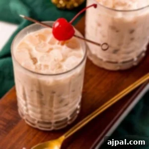 A visually appealing Irish Cream White Russian cocktail, topped with a maraschino cherry, ready to be served, highlighting the creamy texture and inviting presentation.