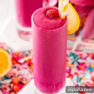 Vibrant Beet Raspberry Blend 12 Two glasses of raspberry beet smoothie with a slice of lemon.
