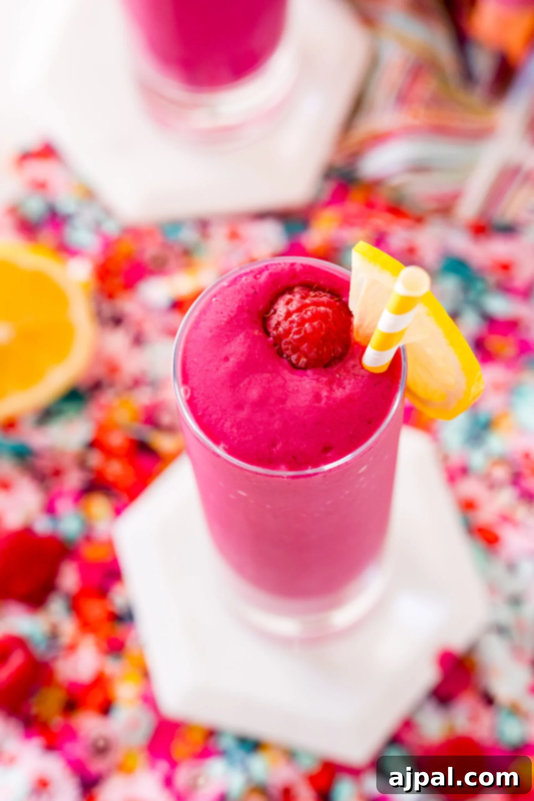 Vibrant Beet Berry Boost 3 A vibrant raspberry smoothie with a lemon slice garnish, showcasing its refreshing quality.