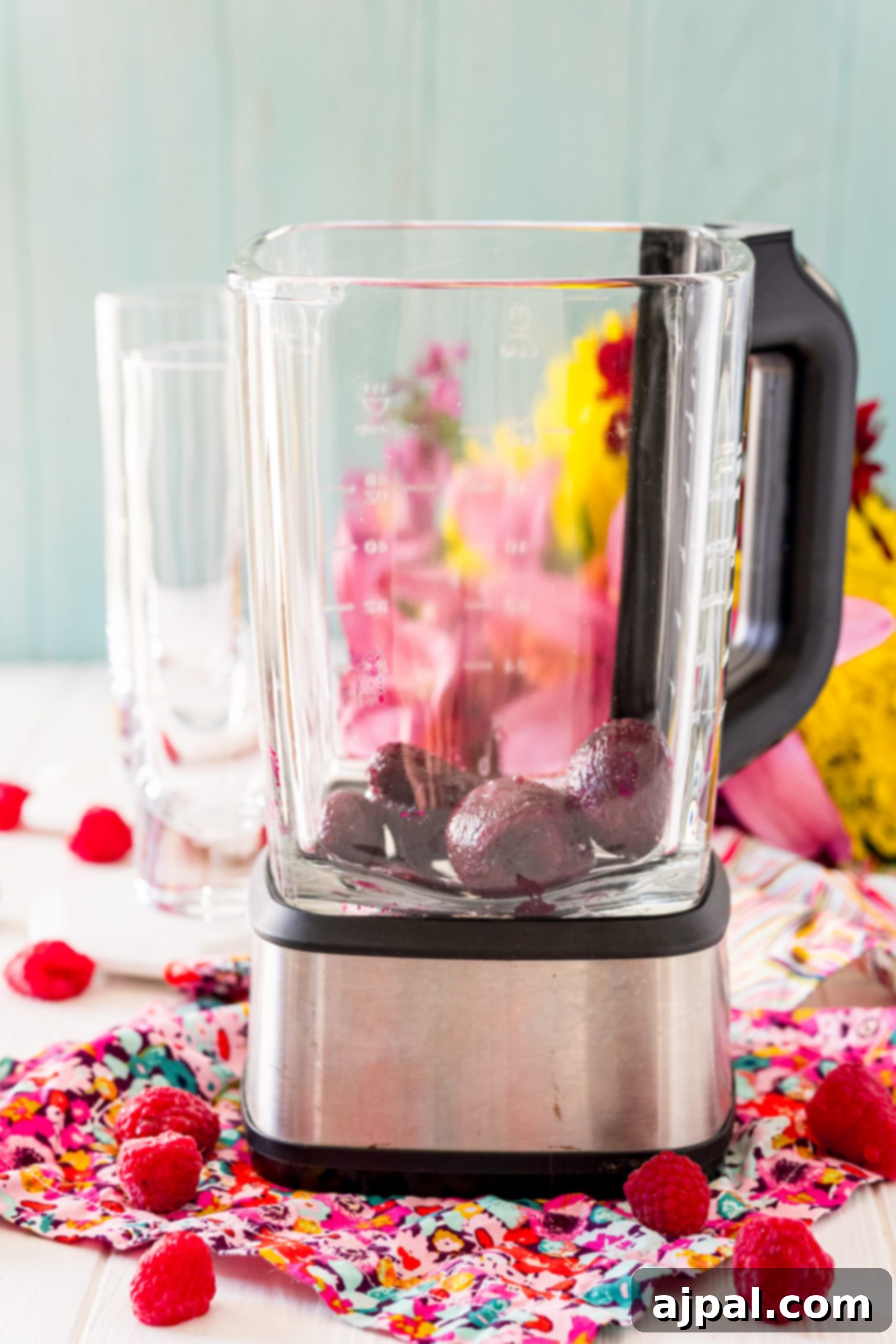 Vibrant Beet Raspberry Blend 8 A blender filled with fresh raspberries on a table, ready for making a Raspberry Beet Smoothie.