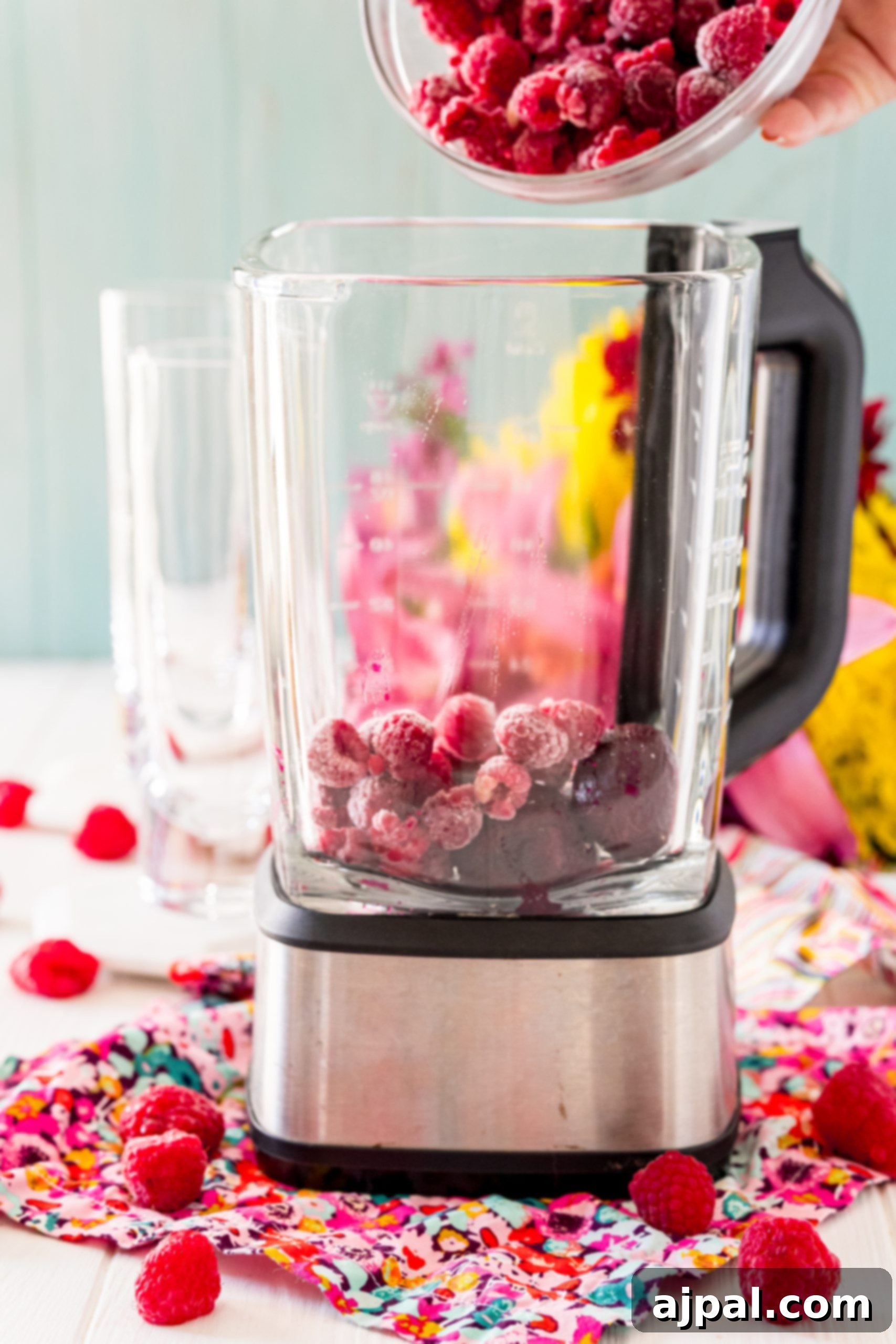Vibrant Beet Raspberry Blend 9 A person blending raspberries in a blender, preparing a protein-rich beet smoothie.