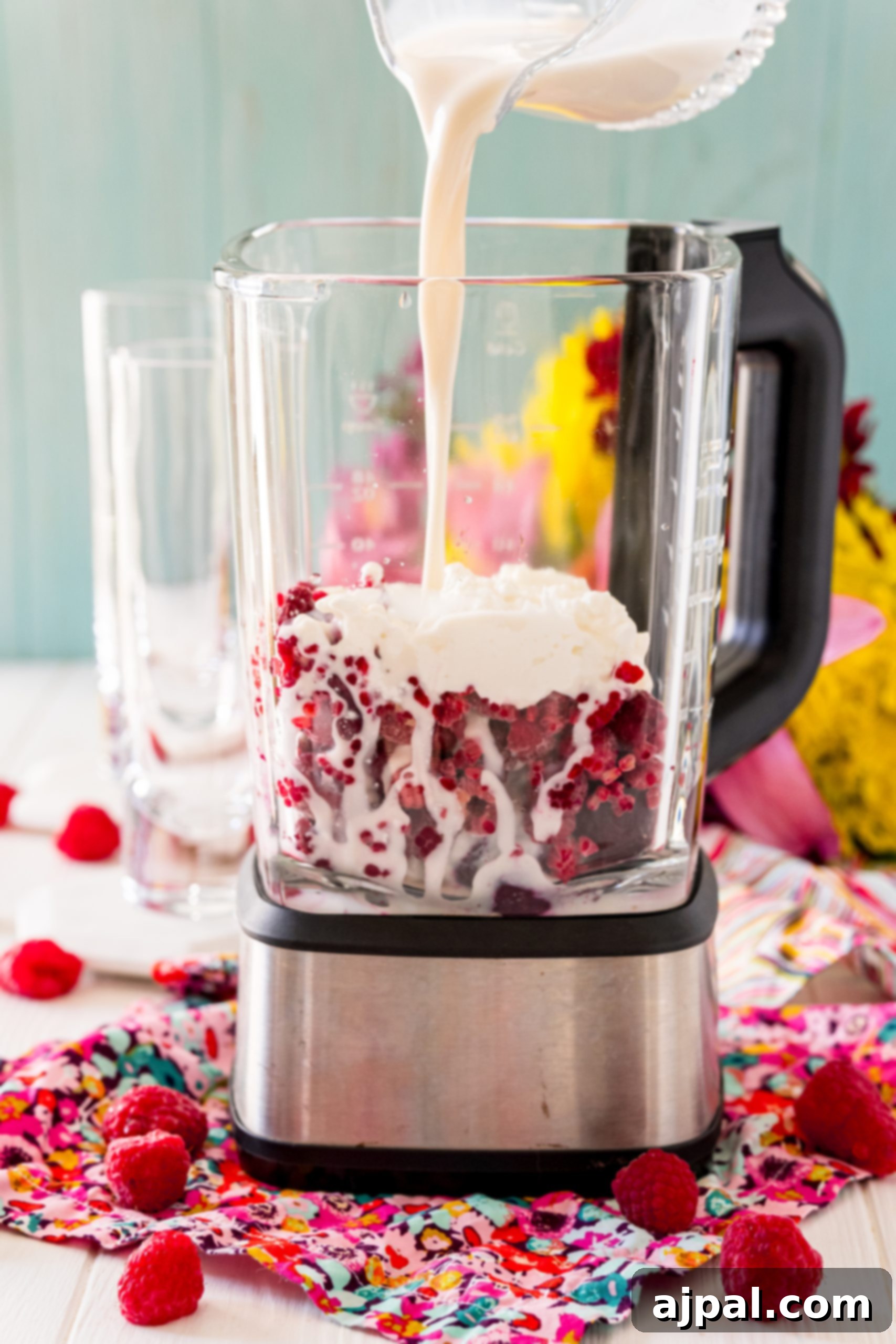 Vibrant Beet Raspberry Blend 10 A blender filled with a vibrant pink mixture of raspberries and cream, making a raspberry beet smoothie.