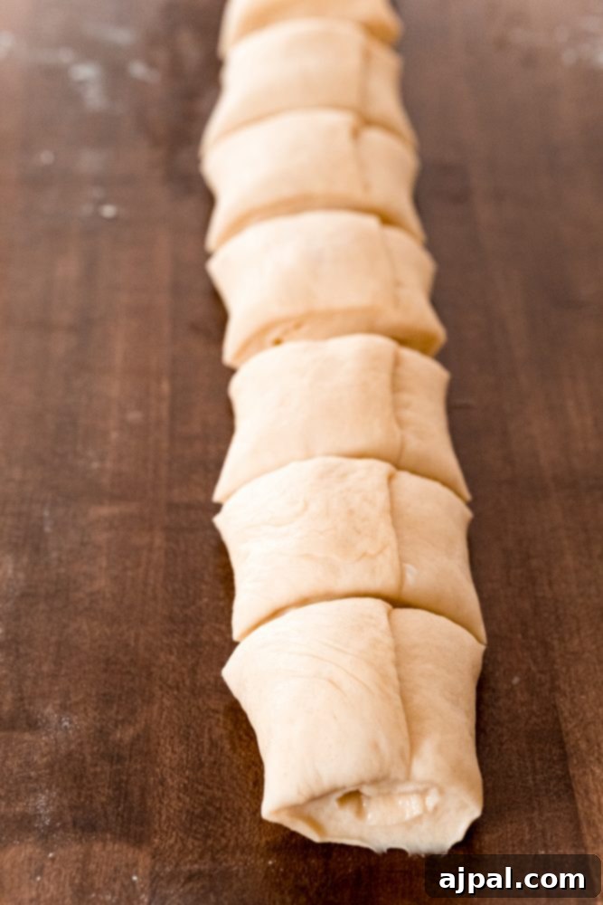 Effortless Melt-in-Your-Mouth Buttery Dinner Rolls 17 picture of bread rolls being cut on table