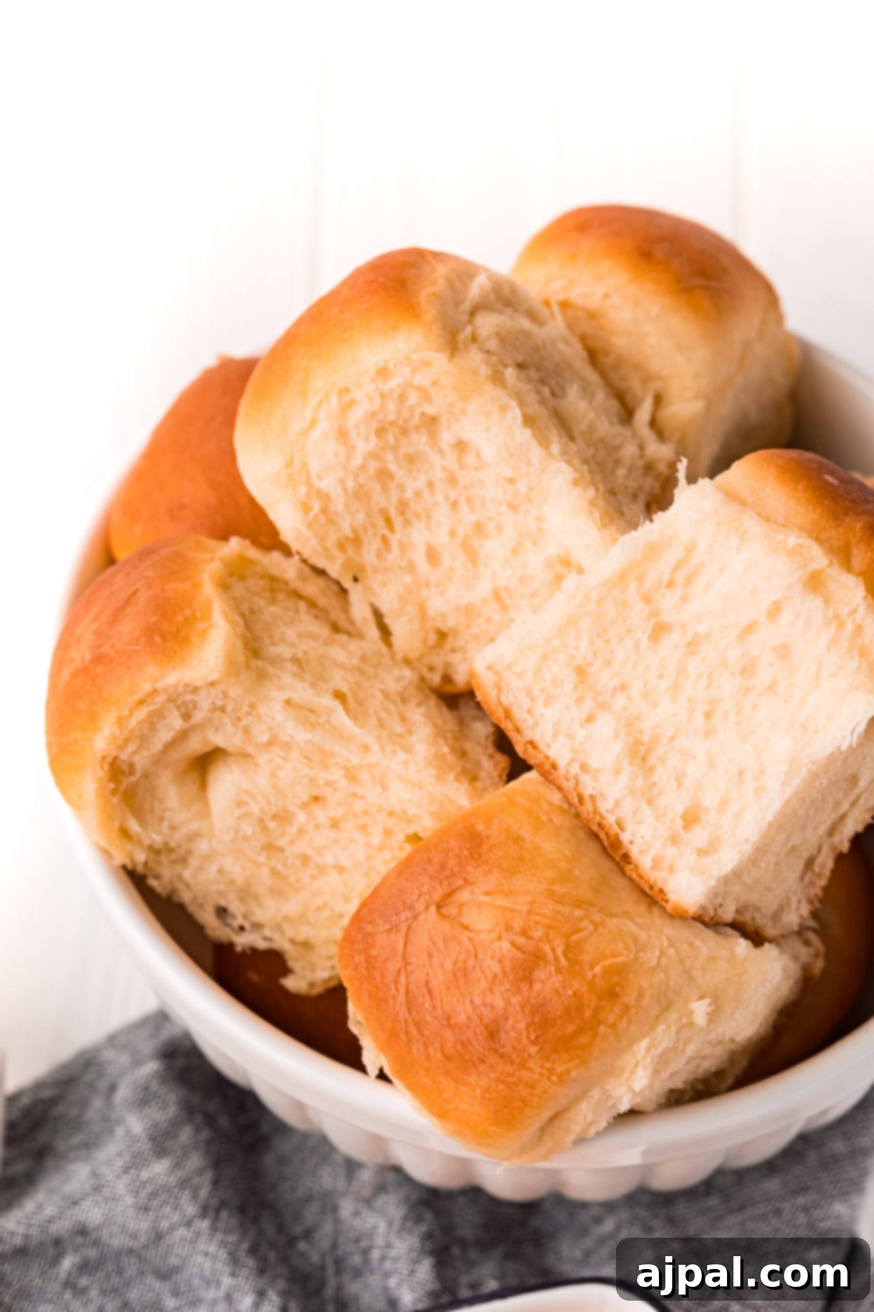 Effortless Melt-in-Your-Mouth Buttery Dinner Rolls 3 picture of soft dinner rolls in a bowl