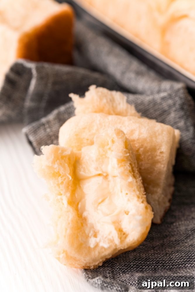 Effortless Melt-in-Your-Mouth Buttery Dinner Rolls 23 picture of buttered dinner roll