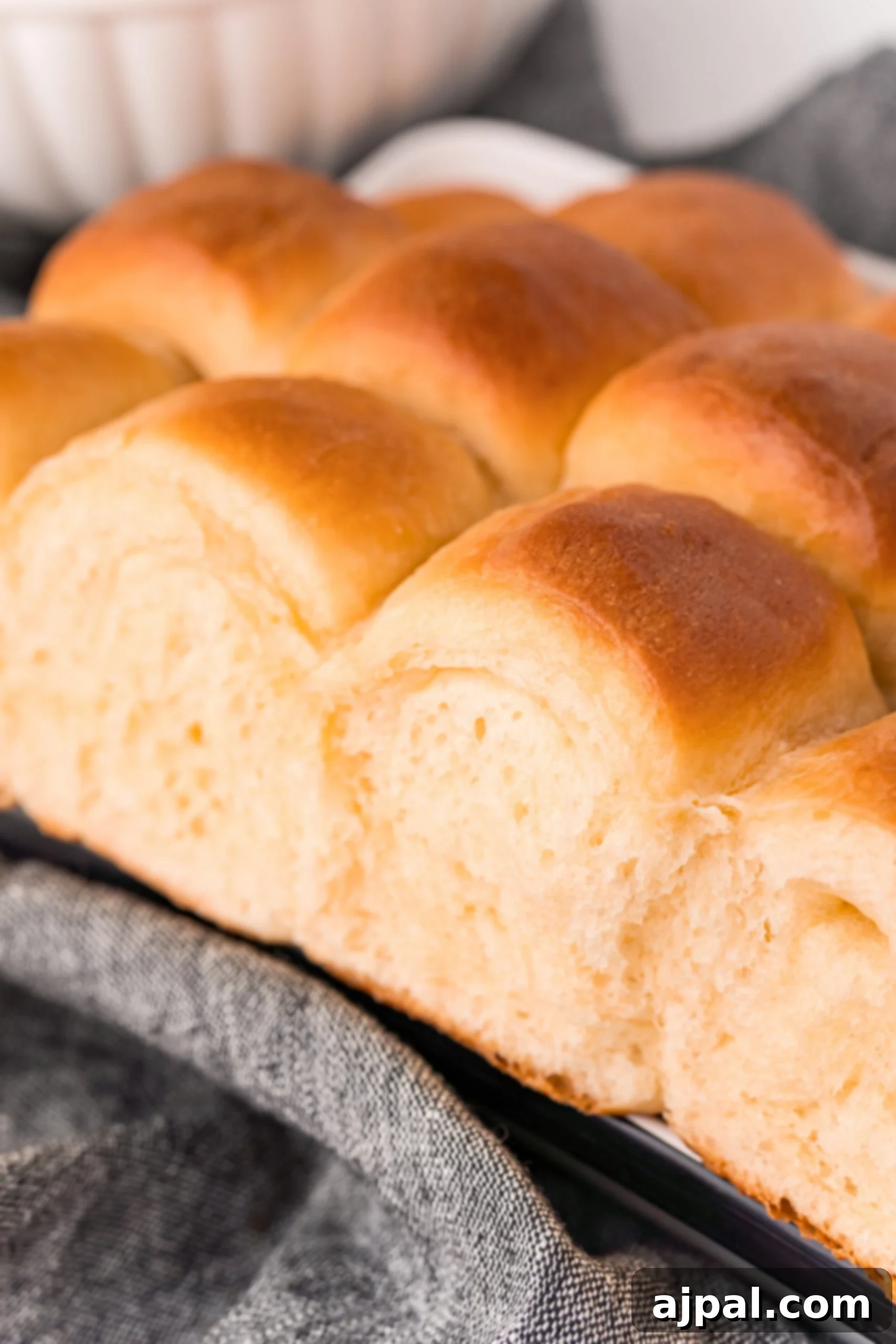Effortless Melt-in-Your-Mouth Buttery Dinner Rolls 4 picture of soft dinner rolls on a towel
