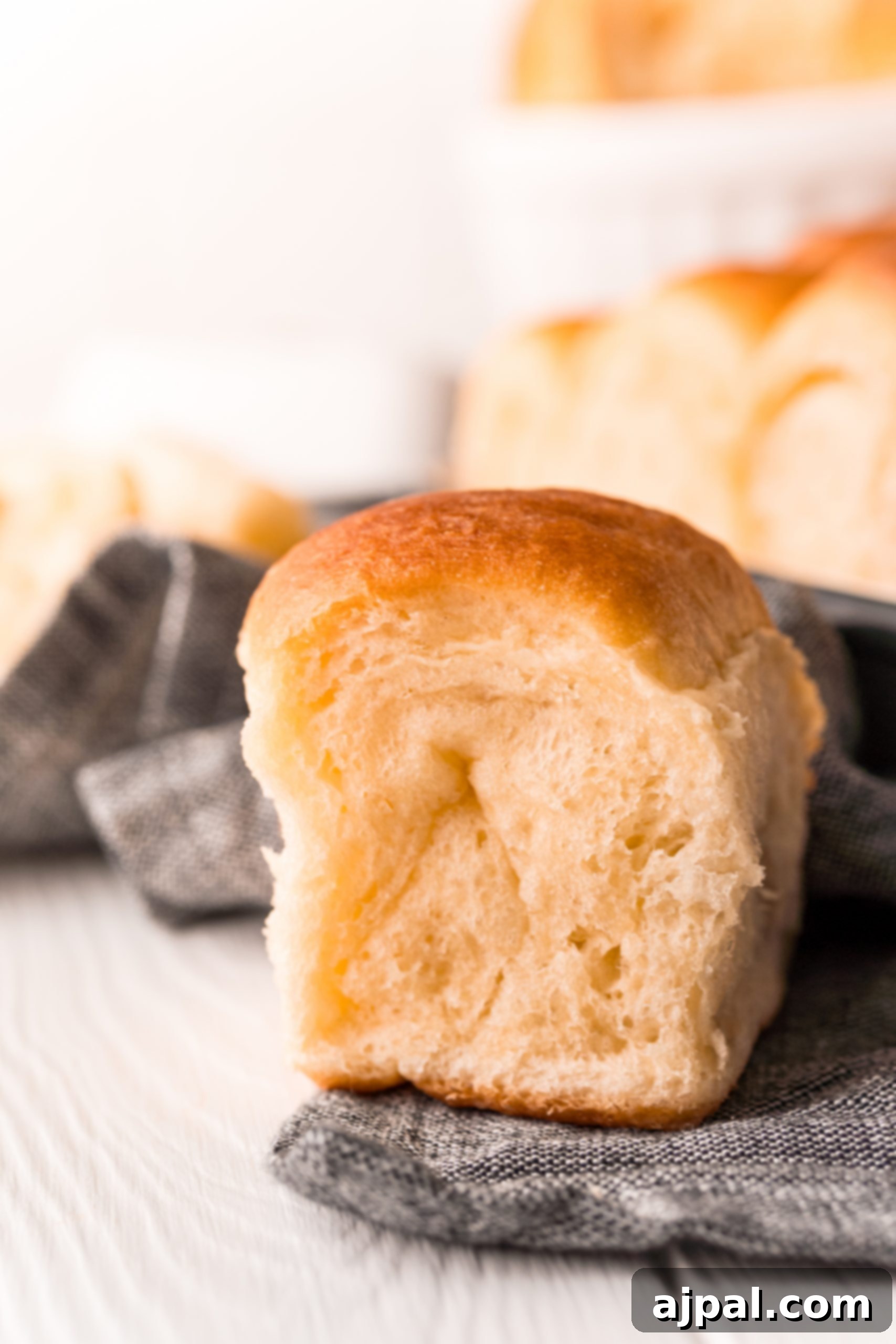 Effortless Melt-in-Your-Mouth Buttery Dinner Rolls 5 picture of soft dinner rolls on a table
