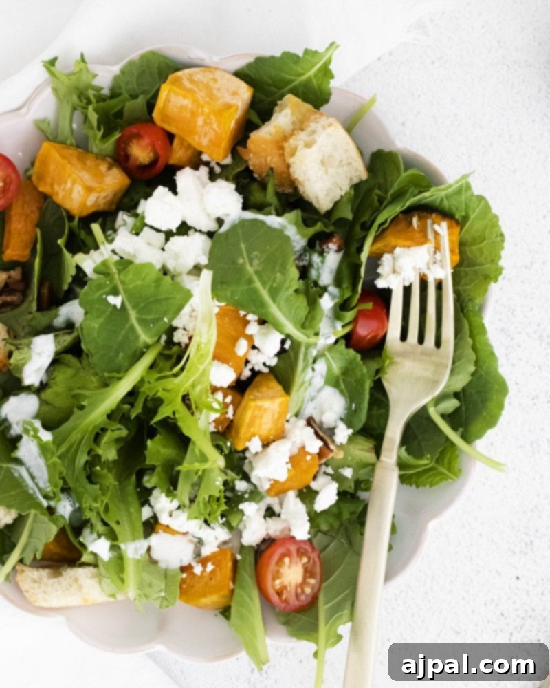 Roasted Sweet Potato Salad with Tangy Goat Cheese 2 A beautifully arranged bowl of Roasted Sweet Potato and Goat Cheese Salad, ready to be enjoyed with a fork.