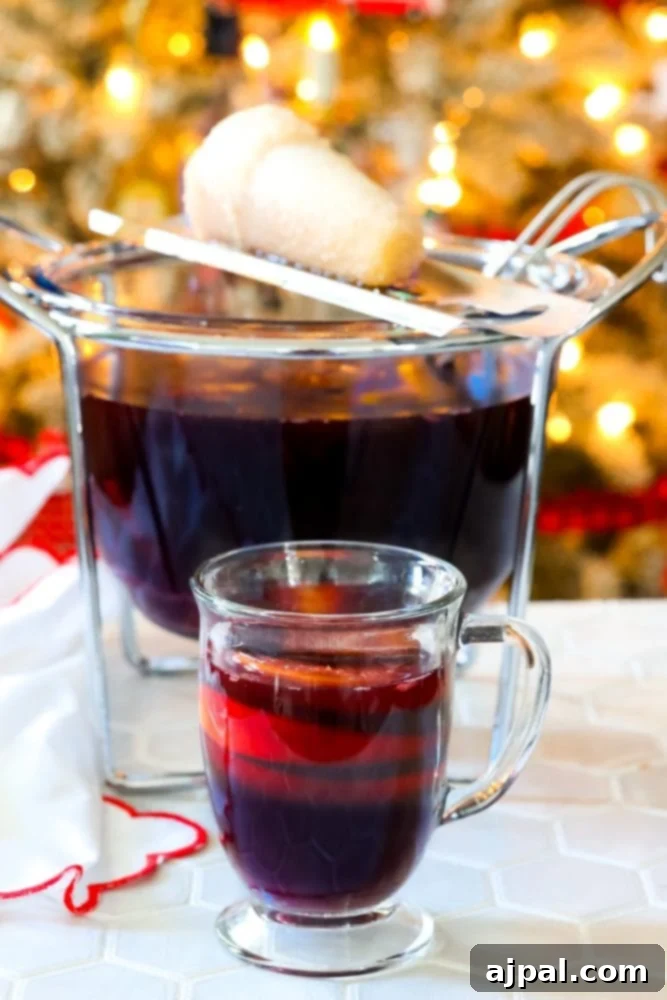 mug with rum punch in front of flaming punch bowl and sugar on fire on top of it