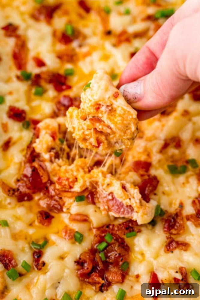 A person indulging in a cheesy bacon dip recipe.