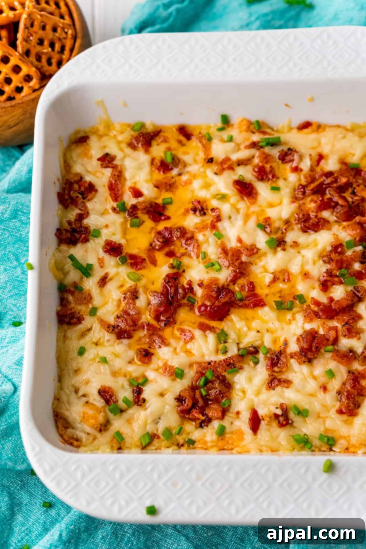 The Best Easy Keto Bacon Cheese Dip Recipe served in a white dish with crackers.