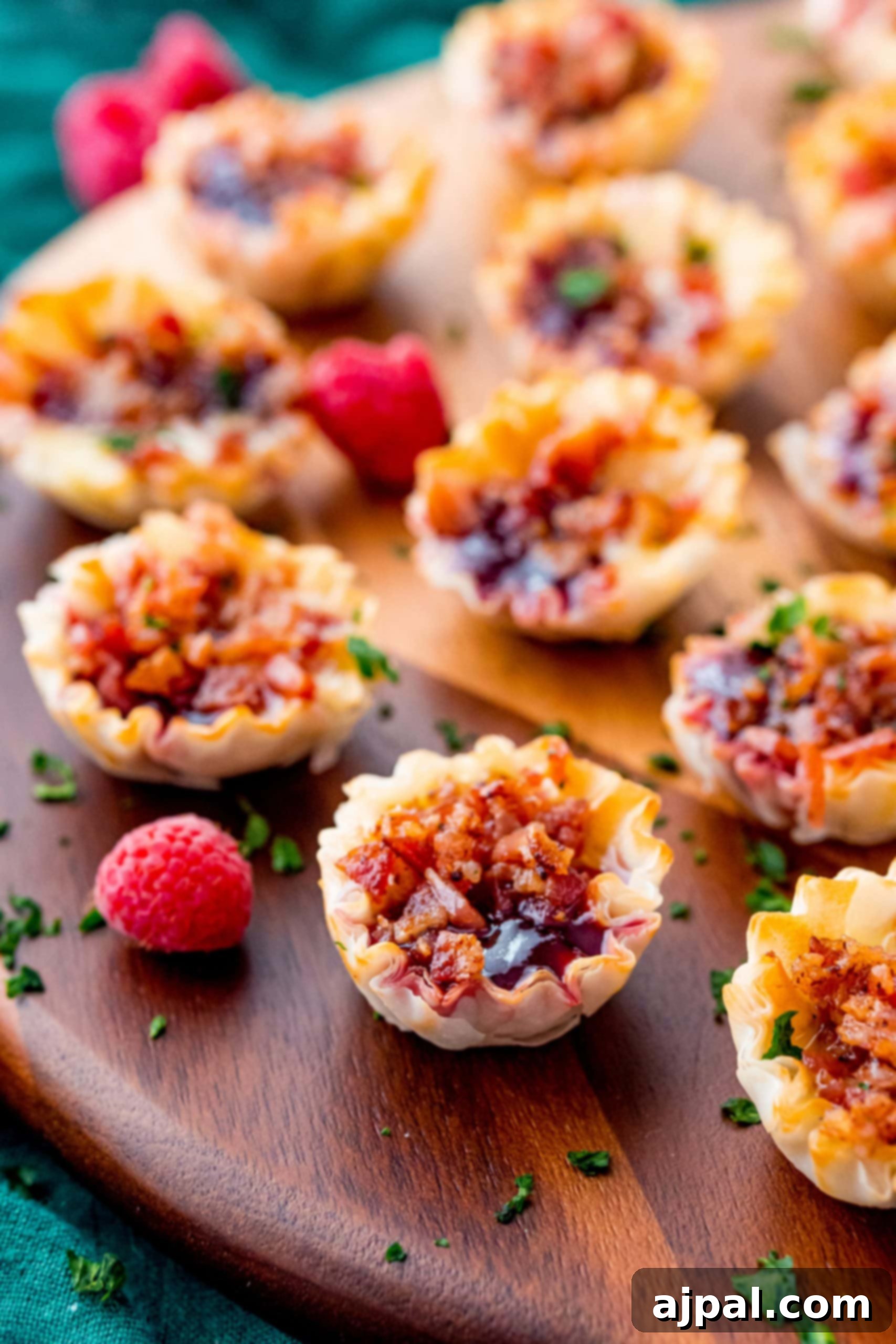 Cheesy Bacon Raspberry Morsels 3 Close-up of elegant mini raspberry bacon tarts, a perfect appetizer for any event.