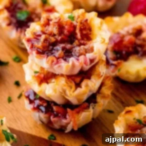 Cheesy Bacon Raspberry Morsels 16 A charming stack of bacon and cheese tarts, perfectly golden and inviting, ready to be enjoyed as a delicious bites recipe.