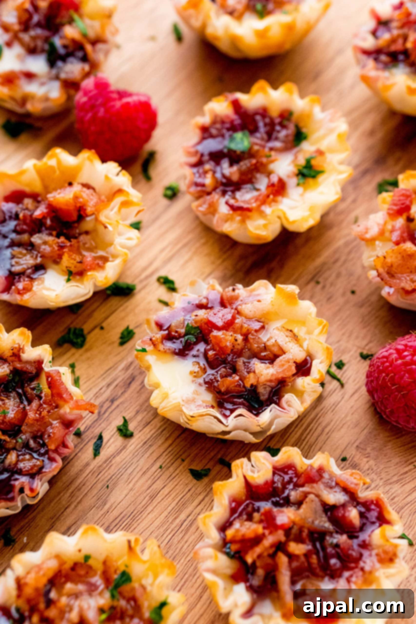 Cheesy Bacon Raspberry Morsels 5 Bacon and cheese bites recipe featuring fresh raspberries, highlighting the sweet and savory combination in mini tart form.