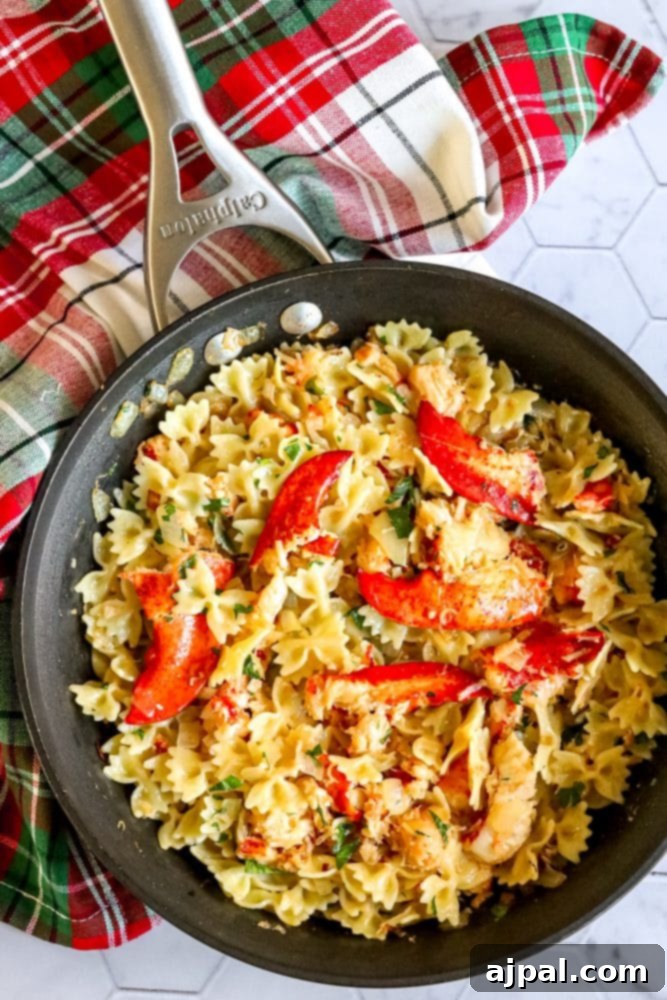Effortless Lobster Pasta Delight 7 bowtie pasta in a pan with herbs, cheese, and lobster meat