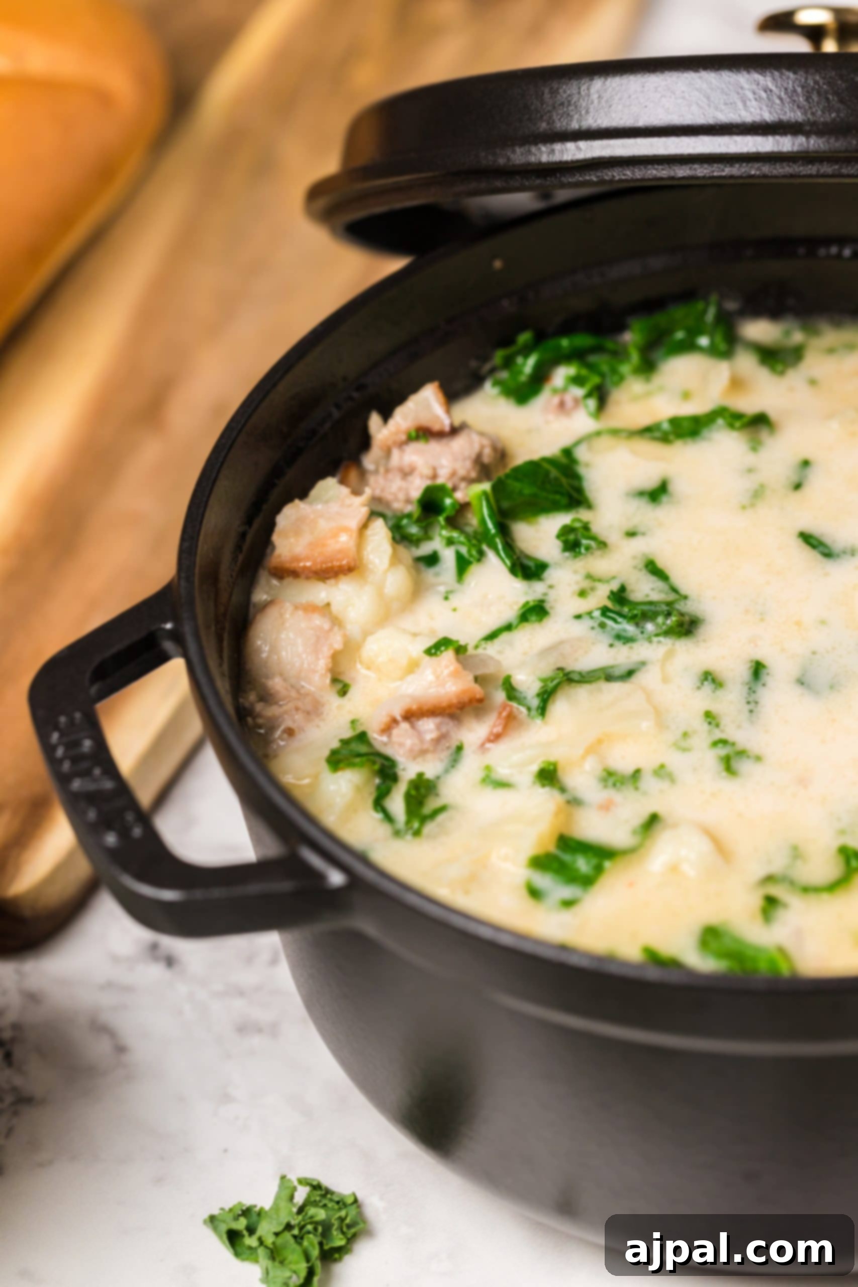 Simple Creamy Keto Tuscan Kale Soup 6 A close-up of a bowl of rich keto soup with kale and meat, ready to be enjoyed.