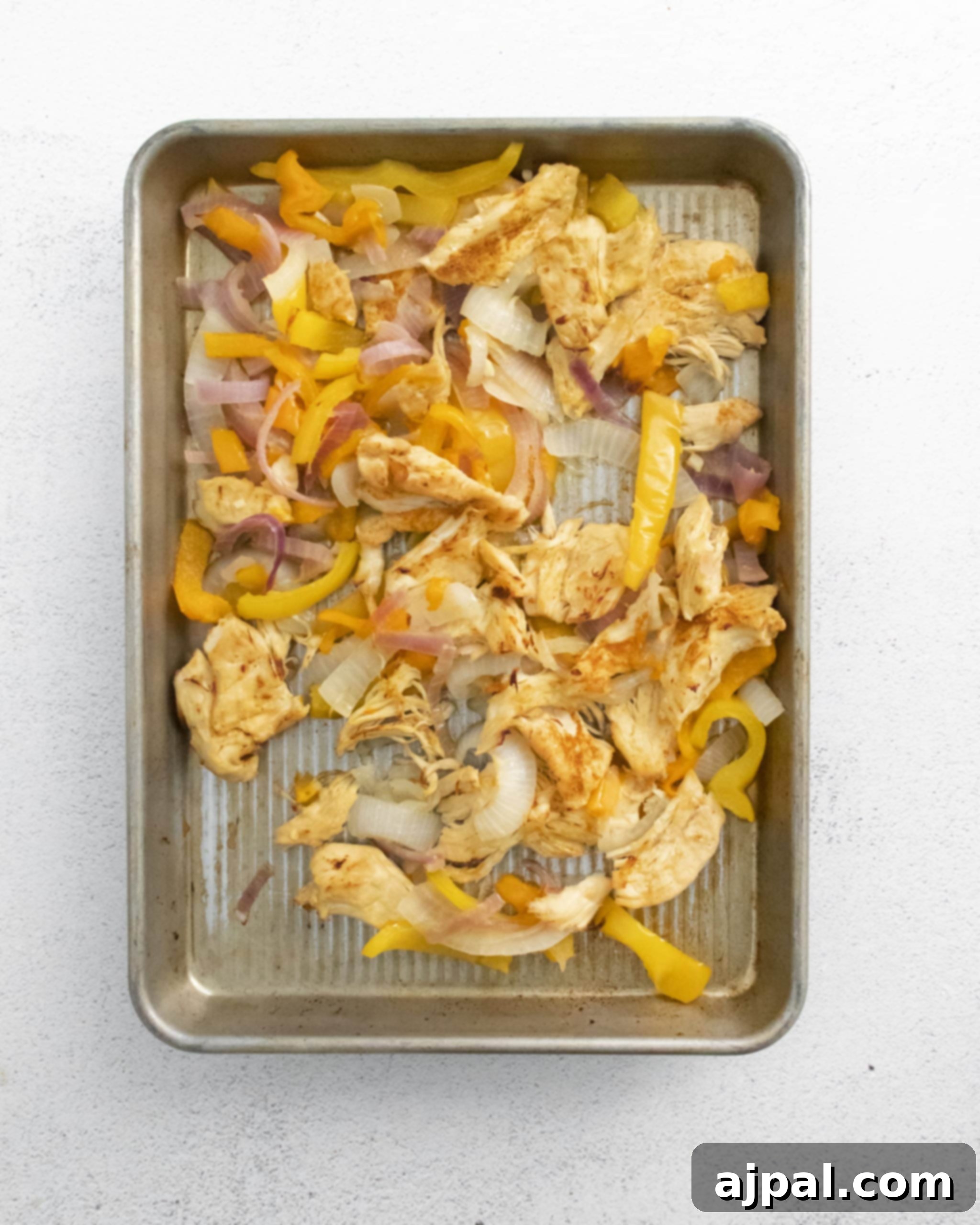 Easy Instant Pot Chicken Fajitas beautifully arranged on a baking sheet, with perfectly charred edges, ready to be served in flavorful bowls.