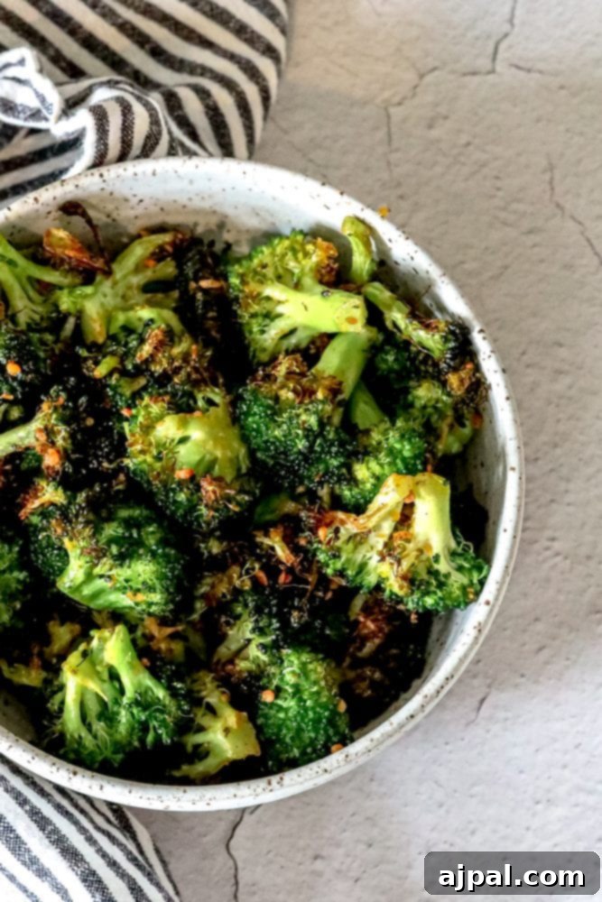 Crispy Air Fried Broccoli 4 Freshly seasoned broccoli florets ready for the air fryer, nestled on a rustic kitchen towel.