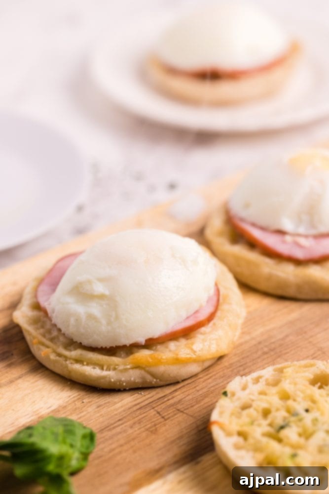 English muffin with Canadian bacon and a perfectly poached egg, awaiting hollandaise sauce.