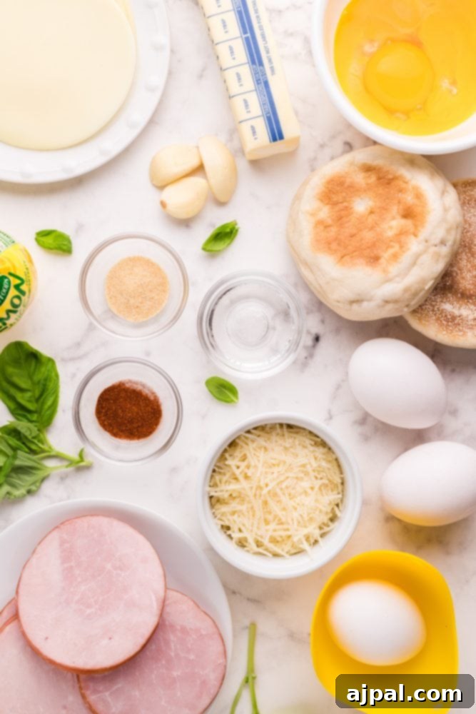 Ingredients for Eggs Benedict laid out: eggs, English muffins, butter, and spices.