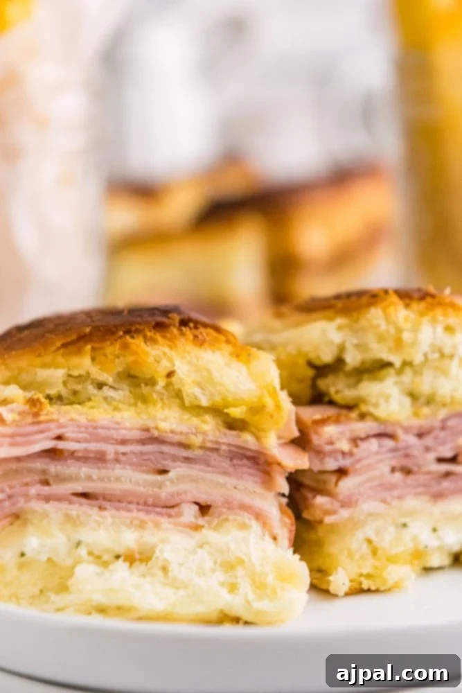 up close picture of ham and cheese sliders. 