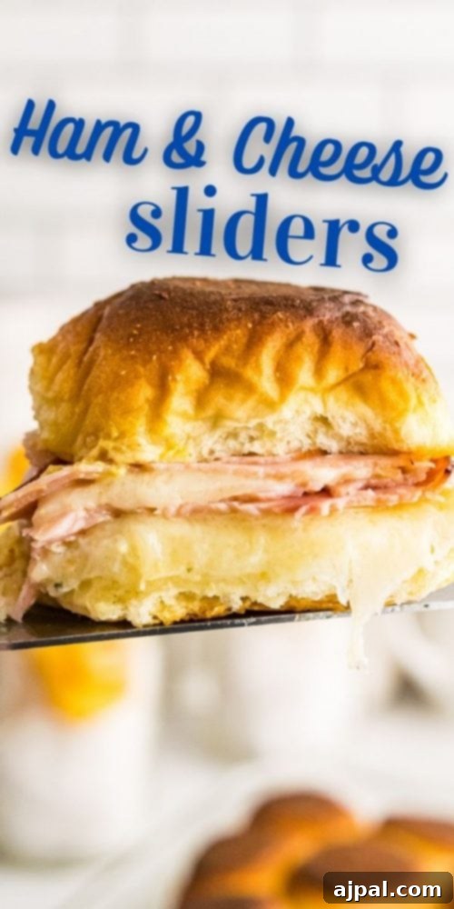 Ham and cheese slider on a metal spatula in the air, with melted cheese visible.
