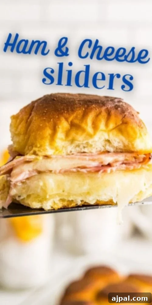 ham and cheese slider on metal spatula in the air. 