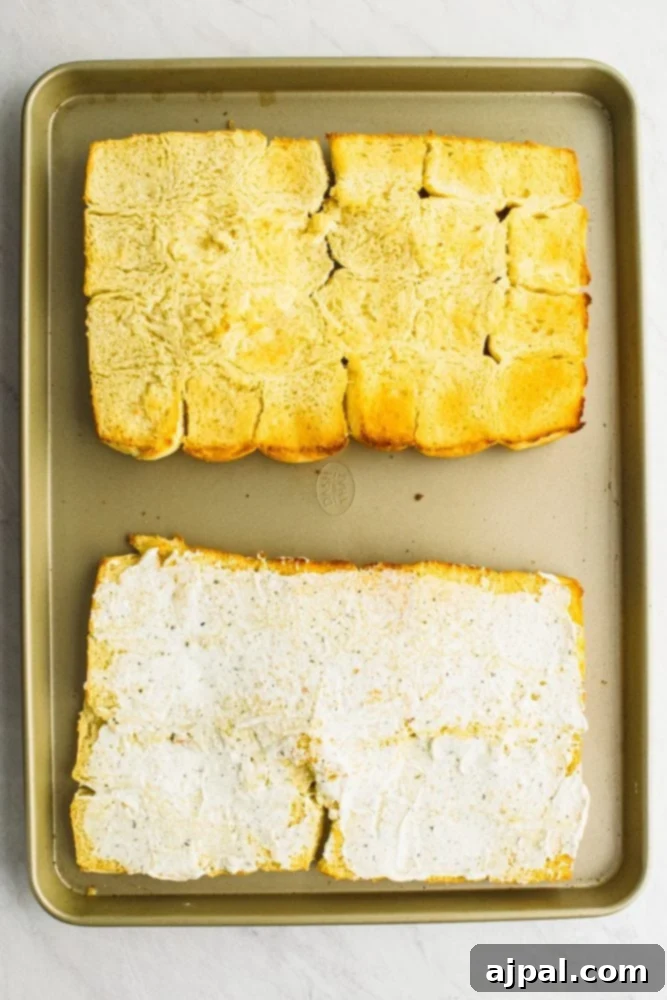 picture of rolls laid out on a sheet pan, one plain, other with butter on it. 