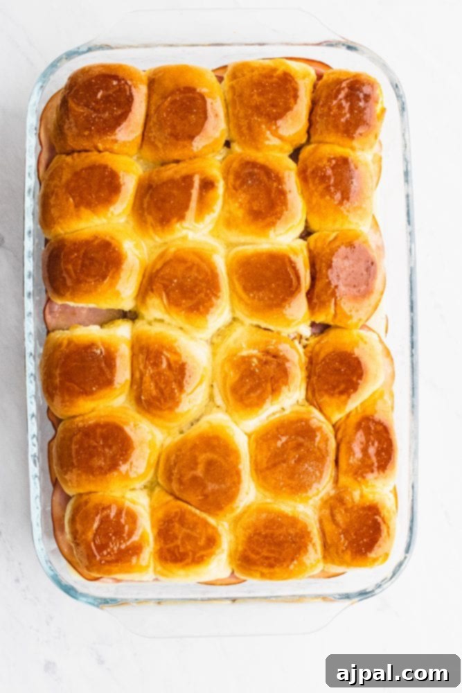 Picture of Hawaiian rolls baked in a glass casserole dish.