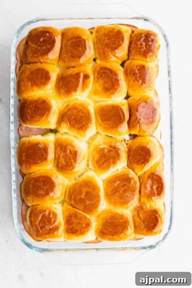 picture of hawaiian rolls baked in a glass casserole dish.