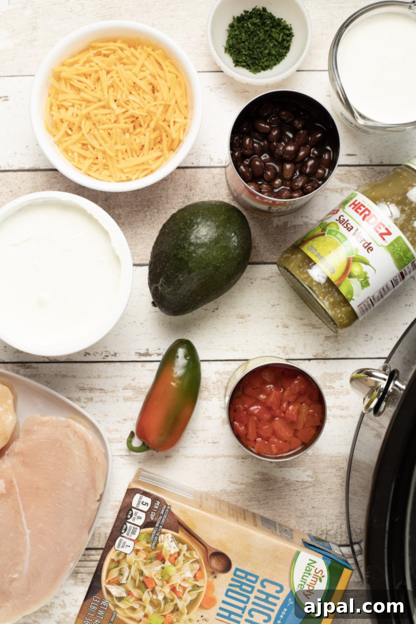 Easy Slow Cooker Chicken Enchilada Soup 7 Crock pot chicken fajitas on a white table.