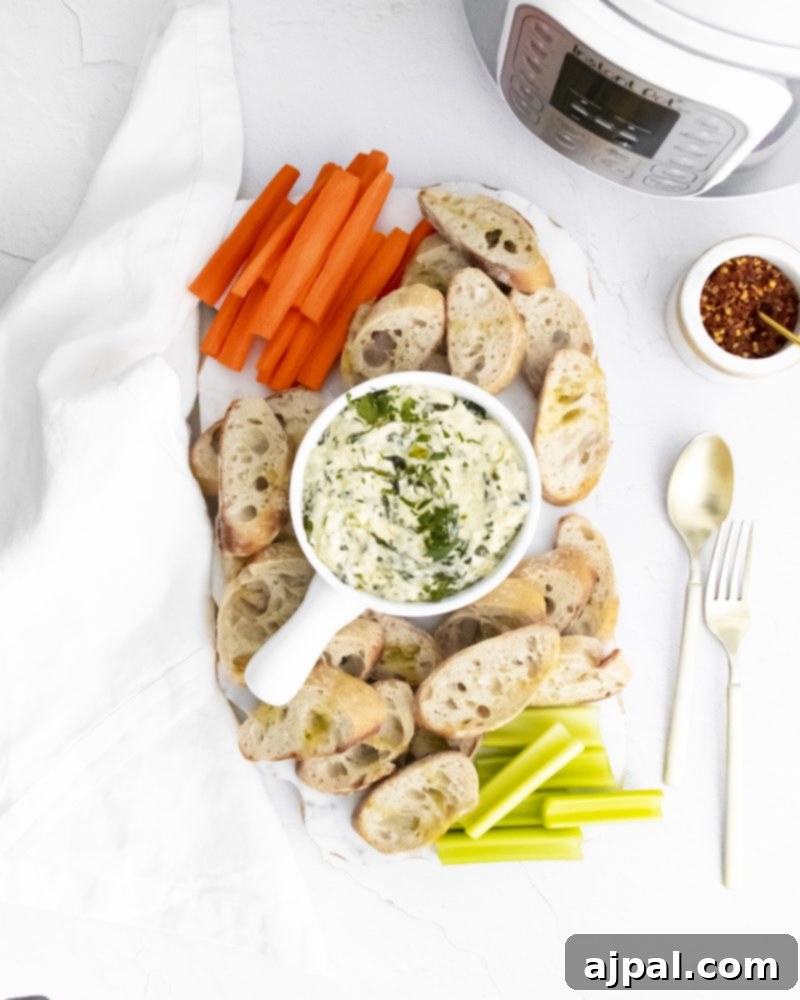 Creamy Instant Pot Spinach Dip 11 Creamy spinach dip with bread and carrots on the side, highlighting perfect serving options.