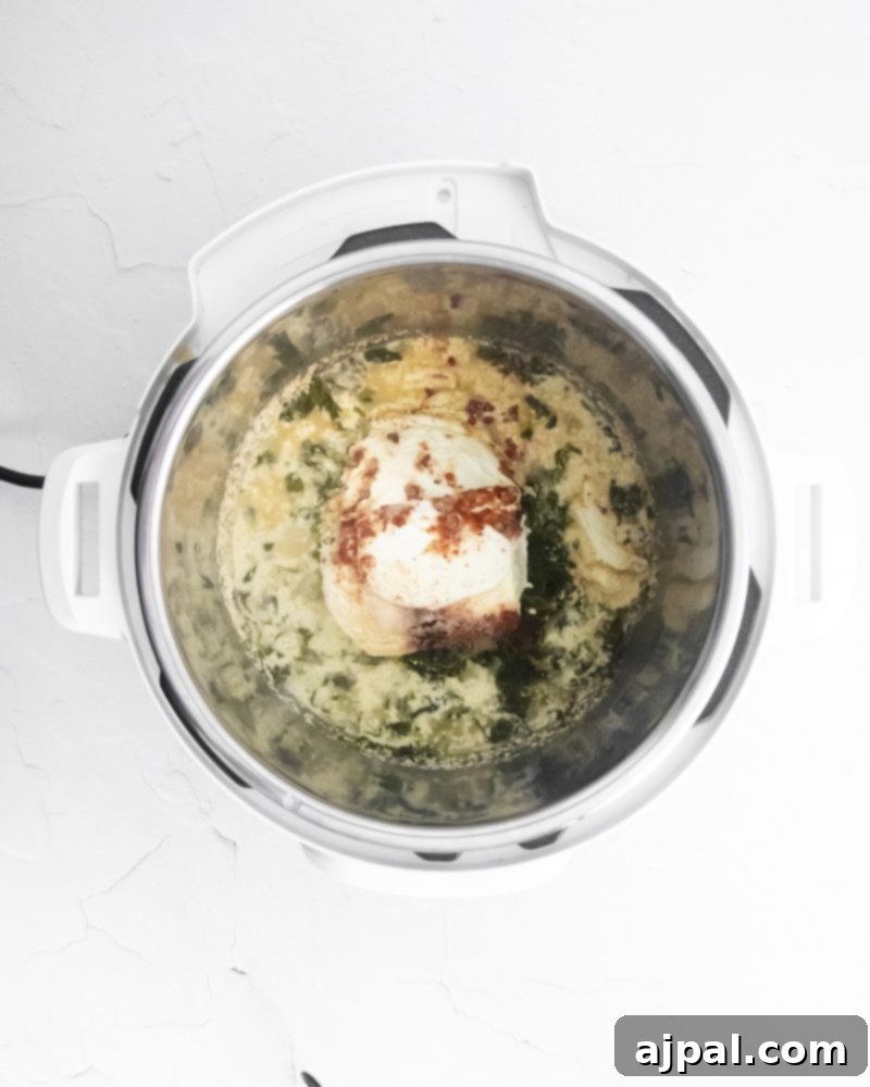 Creamy Instant Pot Spinach Dip 6 Cheese and herbs being added to an Instant Pot, enhancing the flavor of the spinach dip.