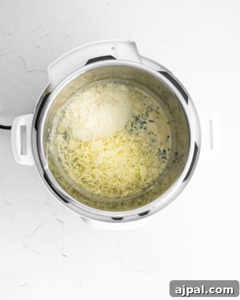 Creamy Instant Pot Spinach Dip 7 Creamy dip with melted cheese in an Instant Pot, showcasing the rich texture.