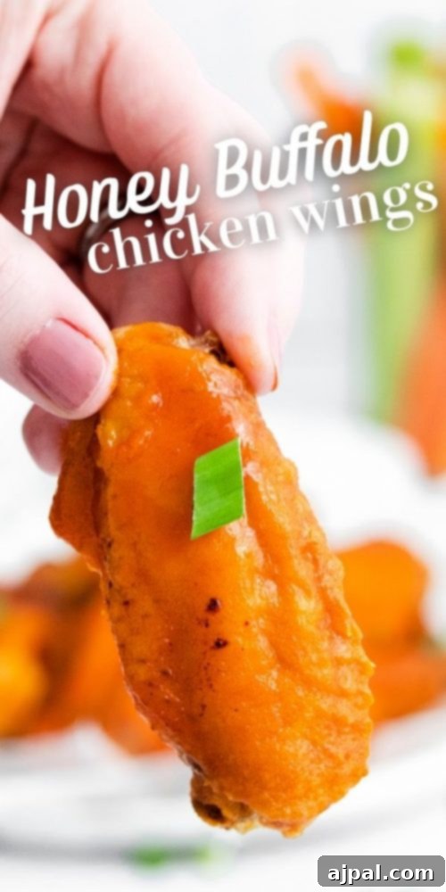 Sticky Sweet Buffalo Wings 7 A close-up of beautifully glazed honey-buffalo chicken wings, glistening with sauce and ready to serve.