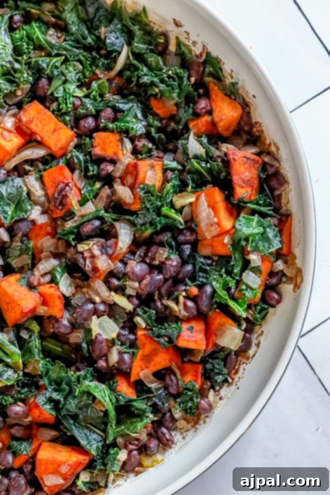 Comforting Sweet Potato, Kale & Black Bean Skillet 2 kale, sweet potatoes, onions, and black beans in a bowl