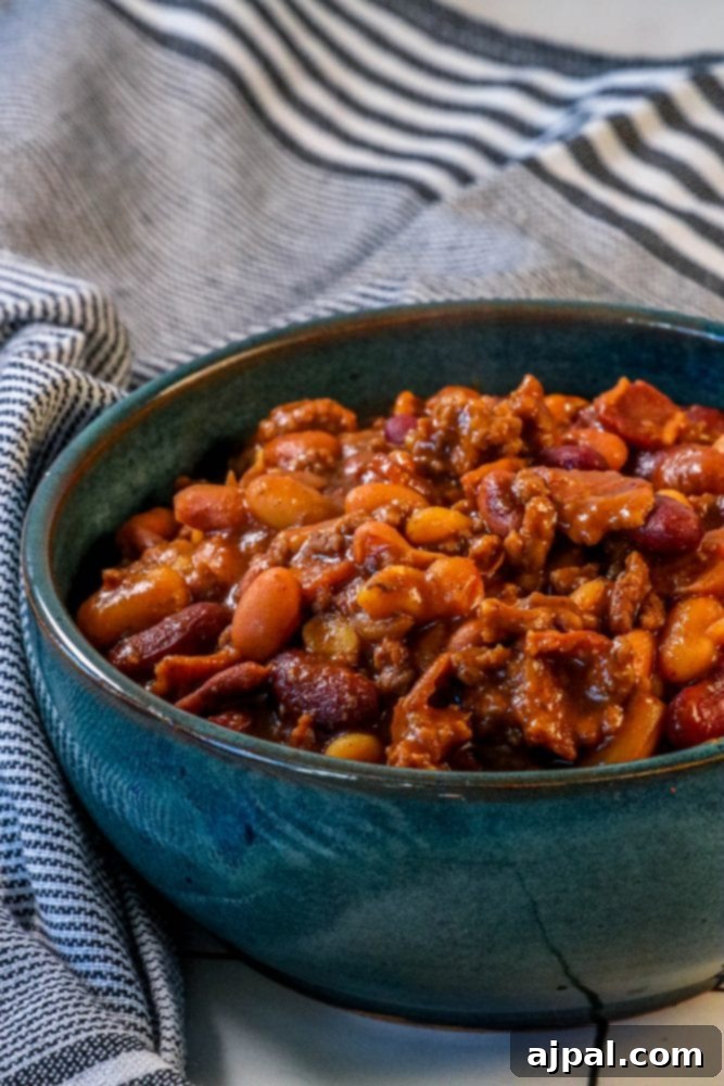 A bowl of rich, savory BBQ baked beans with beef and bacon, perfectly cooked and ready to be served as a delightful side dish.